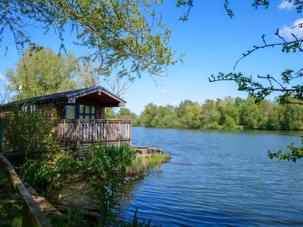 Image of a cabin looking over a lake and really captures the essence of accommodation fishing in norfolk